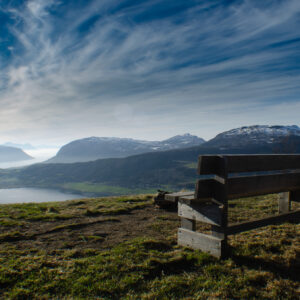 A wooden bench looking out over the fjord at Kilhusåsen, Harstad
