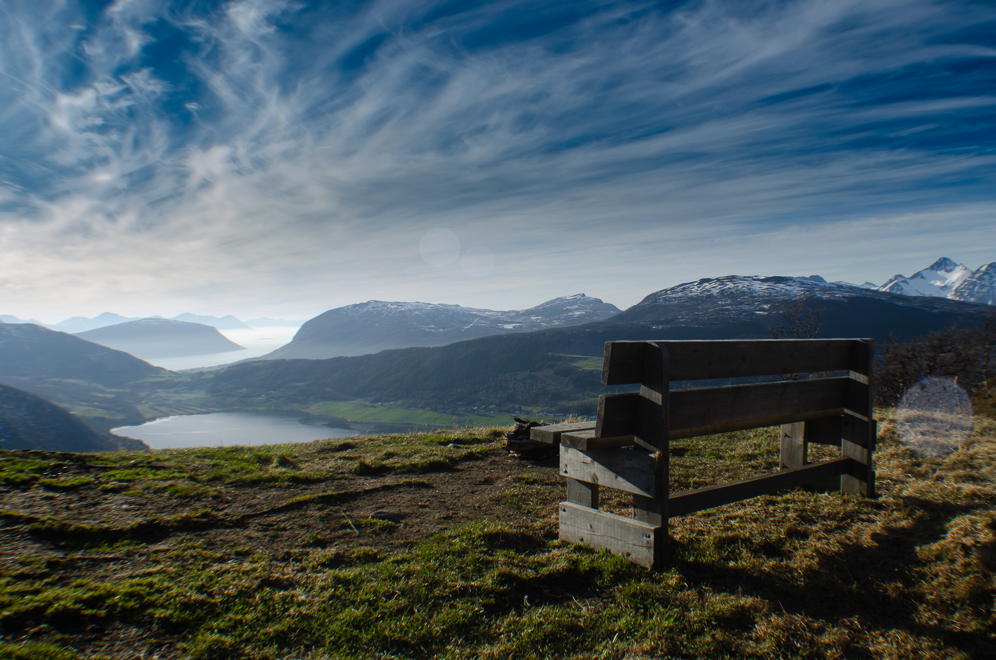 A wooden bench looking out over the fjord at Kilhusåsen, Harstad