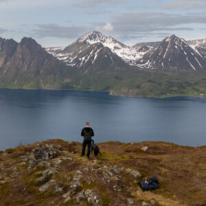 A lone figure on a summit above the fjord at Litlehornet, Aunfjellet
