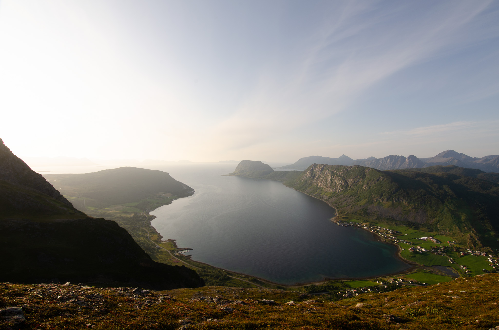 A fjord glowing under backlight at Nontuva, Harstad