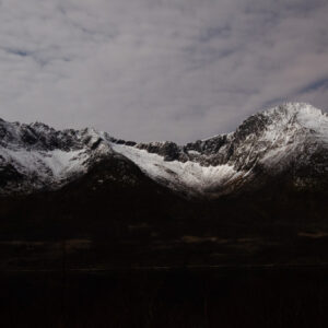 Snow-dusted peaks under a heavy sky at Skålneset, Sørfjorden