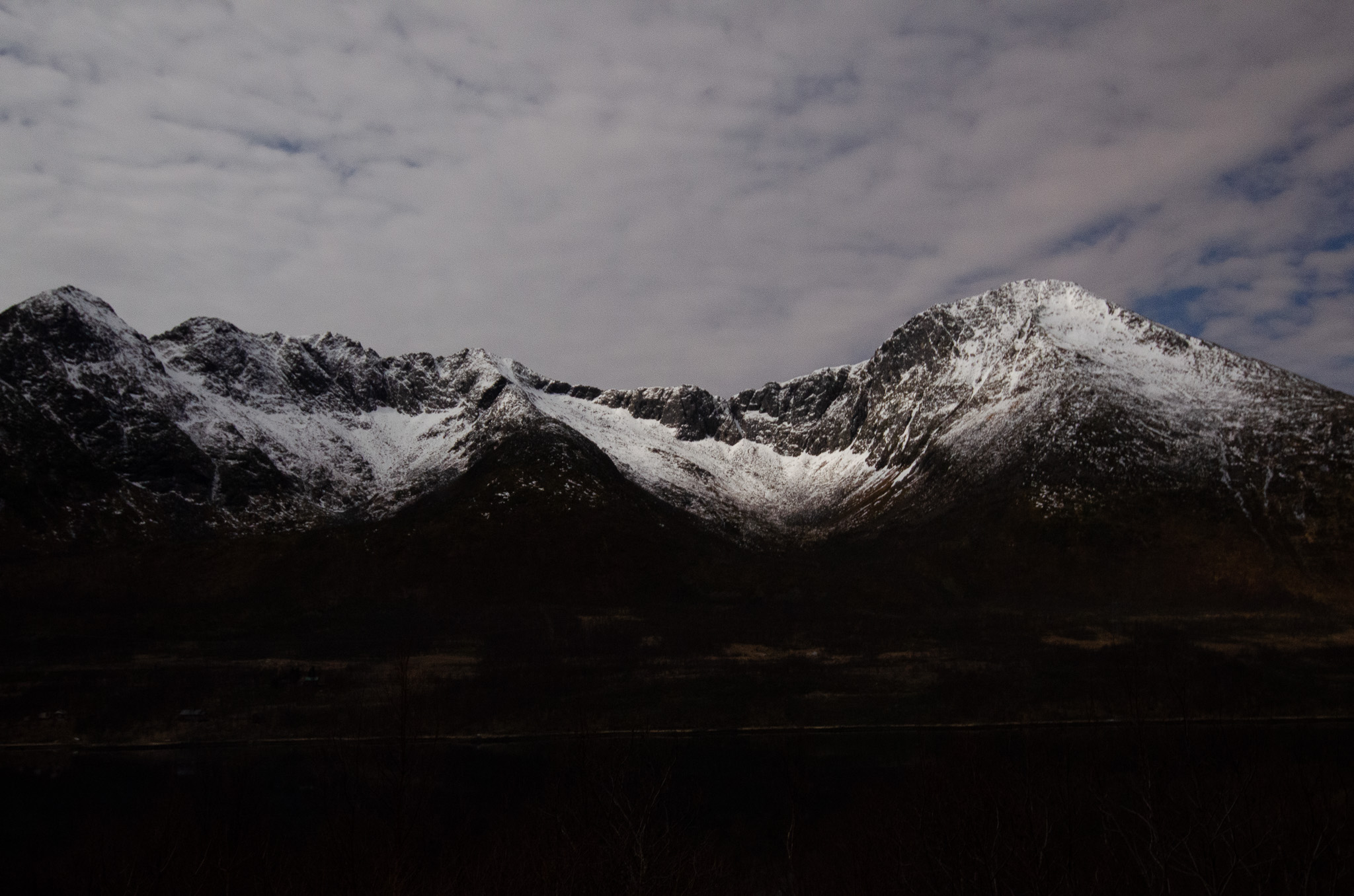 Snow-dusted peaks under a heavy sky at Skålneset, Sørfjorden