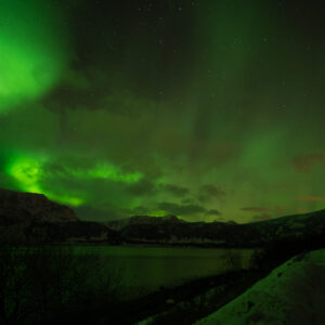 Northern lights sweeping over the fjord at Nupen, Kvæfjord