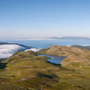 A summit lake with cloud beyond at Storlitinden, Harstad