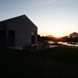 A timber house against the low sun at Skagenhaugen, Bø i Vesterålen