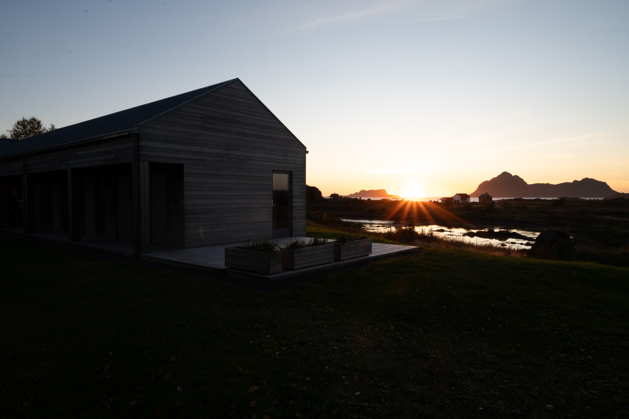 A timber house against the low sun at Skagenhaugen, Bø i Vesterålen