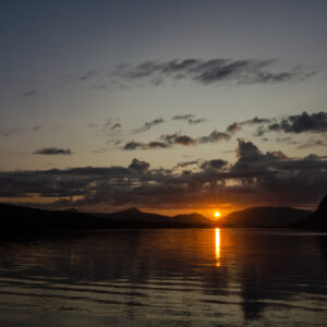 Sunset reflected between dark peaks at Djupfjordbotn, Djupfjorden