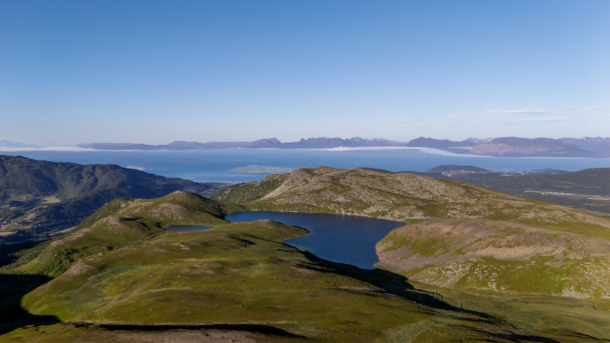 A small mountain lake in green highland at Trøytthågen, Harstad