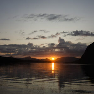 A column of sunlight down a calm fjord at Djupfjordbotn, Djupfjorden