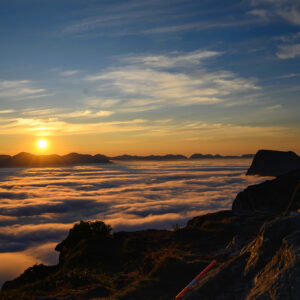 Sun rising over an ocean of cloud seen from a mountain summit