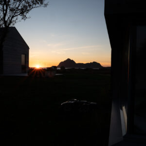Sunset seen past a dark building edge at Skagenhaugen, Bø i Vesterålen