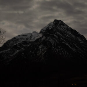 A black pyramid peak against the sky at Skålneset, Sørfjorden