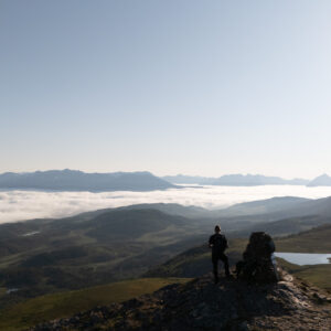 Two hikers on a ridge above the cloud at Storlitinden, Harstad