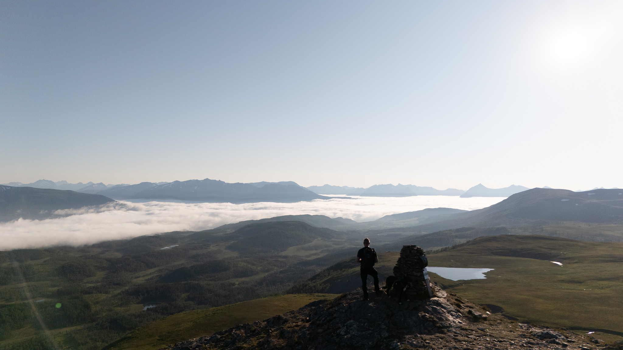 Two hikers on a ridge above the cloud at Storlitinden, Harstad