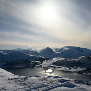 Moon over a snow-covered arctic coastline and frozen inlets